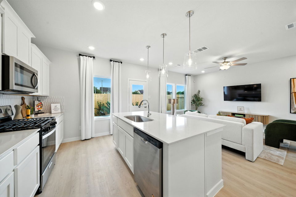 A kitchen with white cabinets.