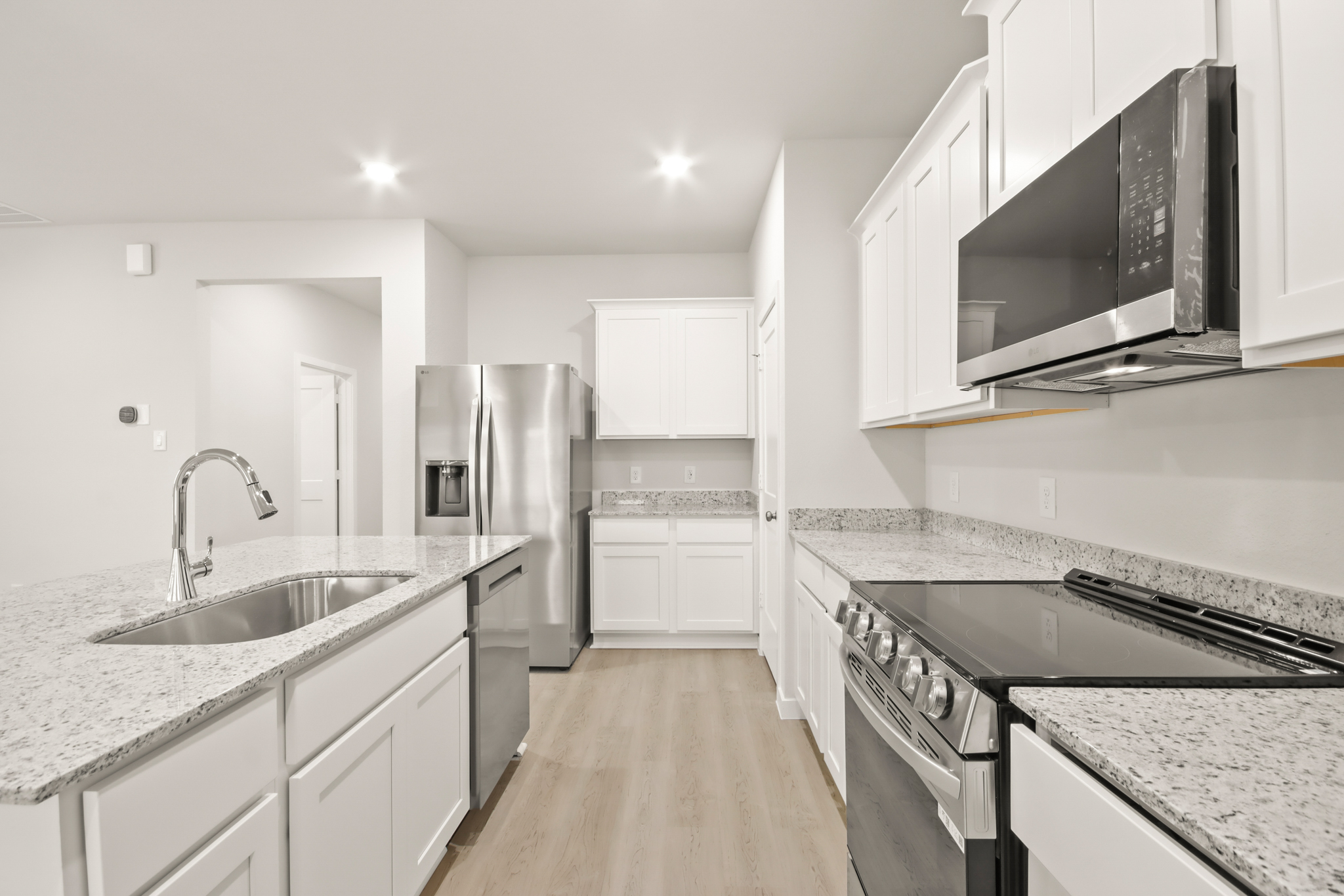 A kitchen with white cabinets.