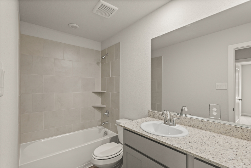 A bathroom with a marble countertop.