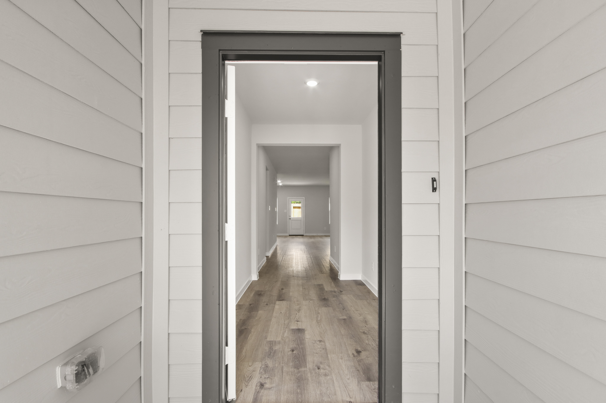 A hallway with a wood floor.