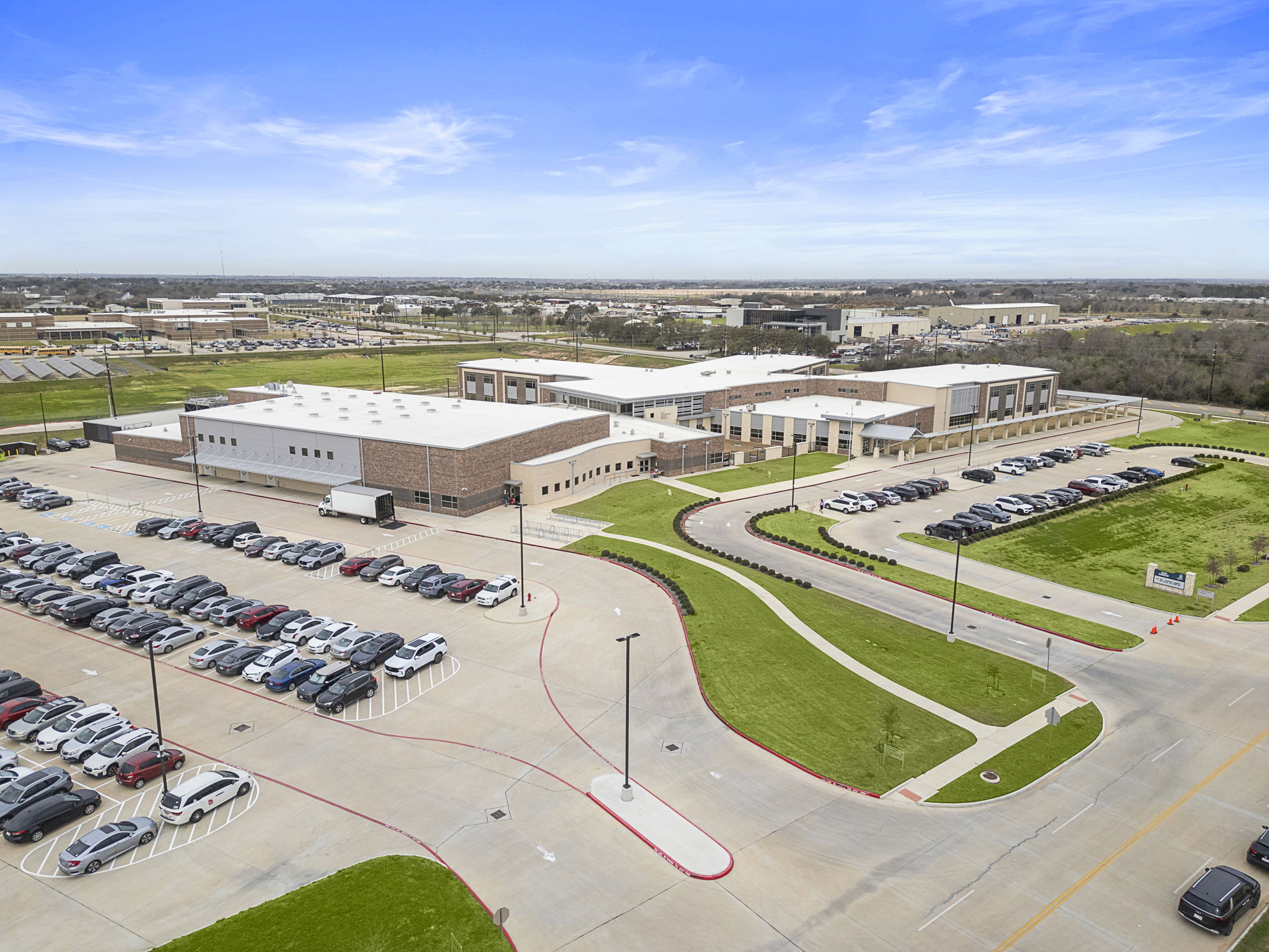 A parking lot with cars and buildings.