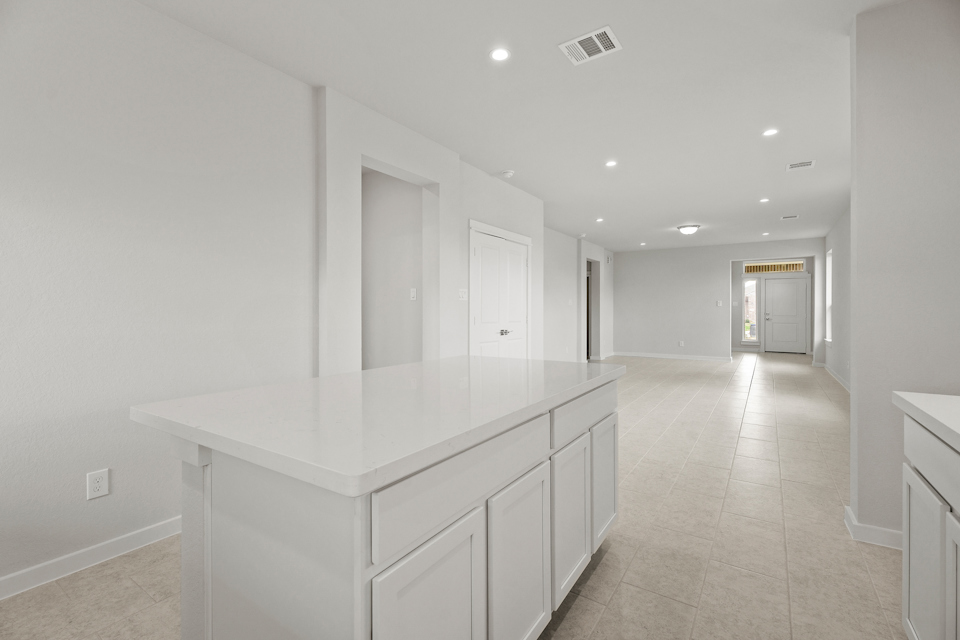 A large white room with white cabinets.