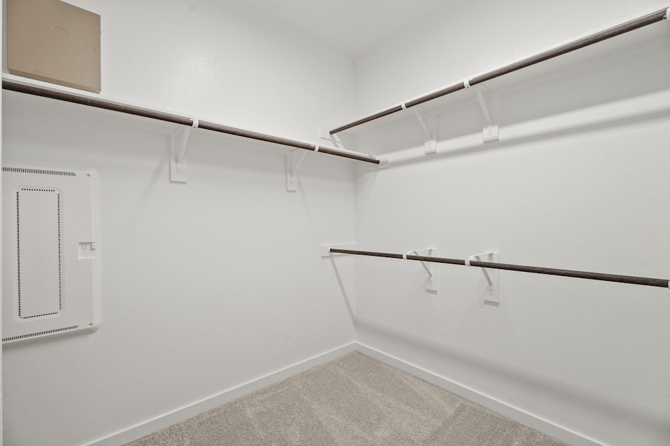 A white wall with a metal bar.