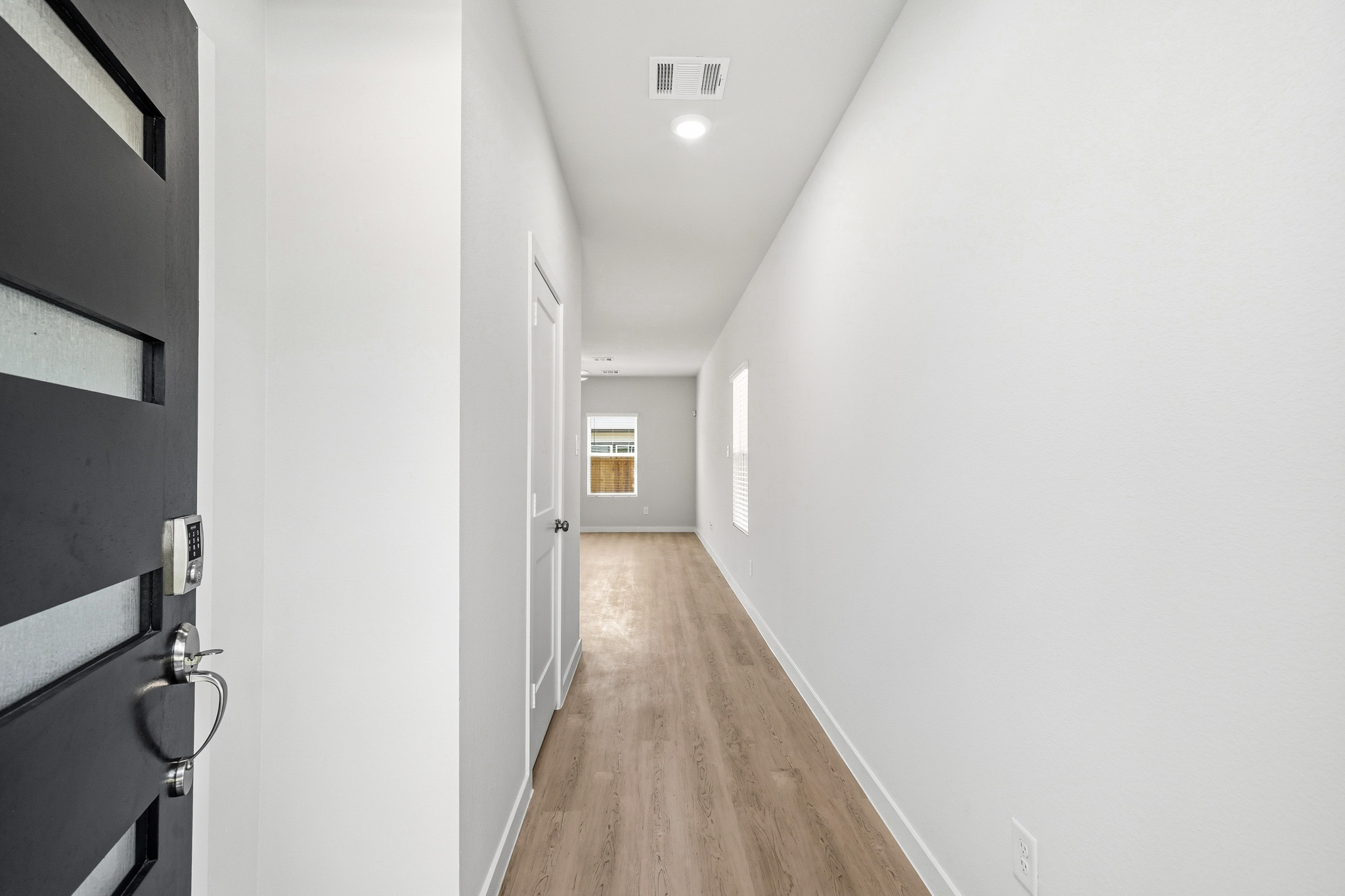 A hallway with white walls.