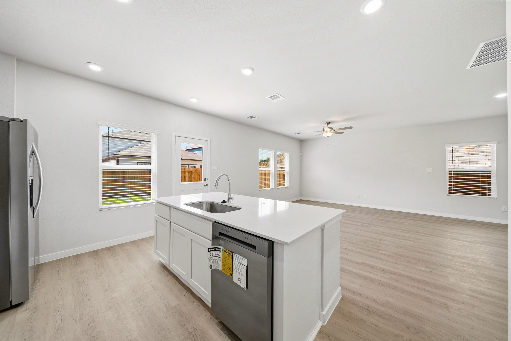 A kitchen with white cabinets.