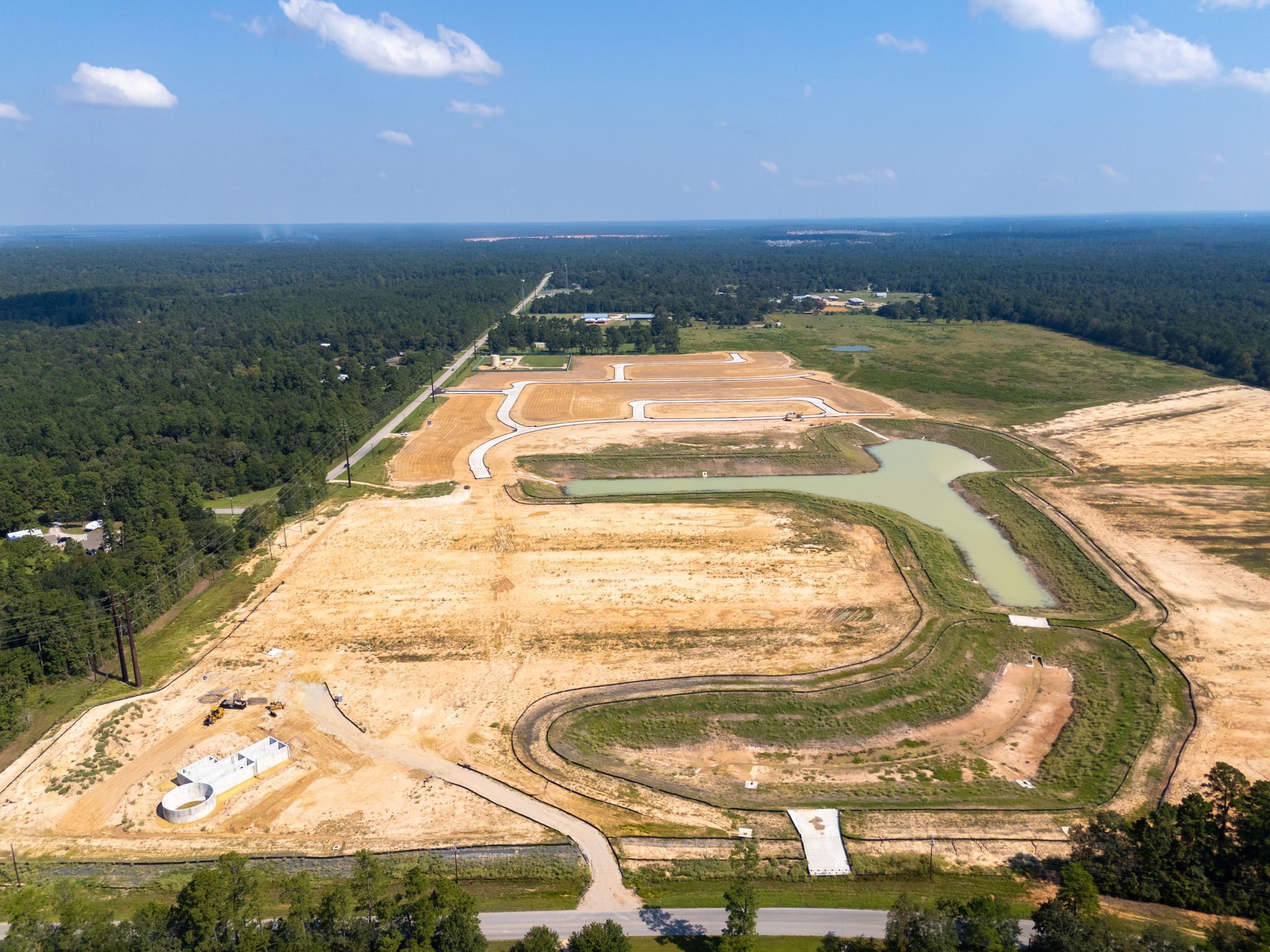 A large area of land with a body of water in the background with Lookout Mountain in the background.