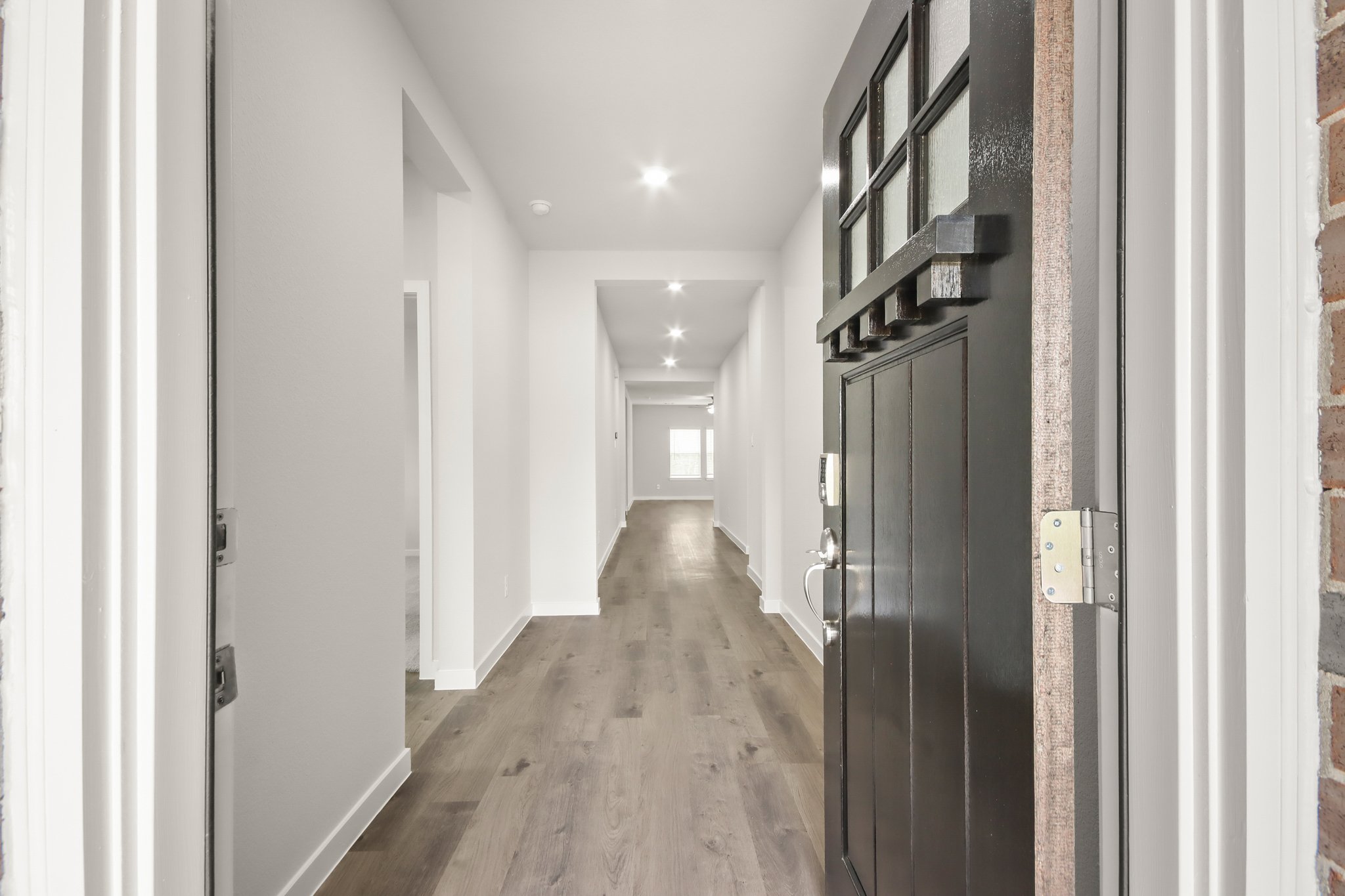 A hallway with black doors.