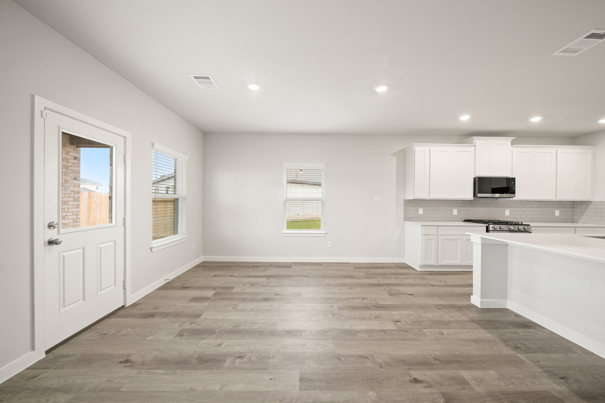 A kitchen with white cabinets.