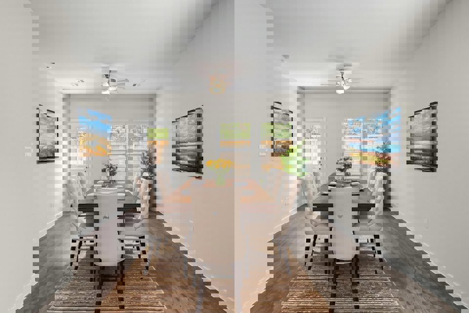 A dining room table with chairs.