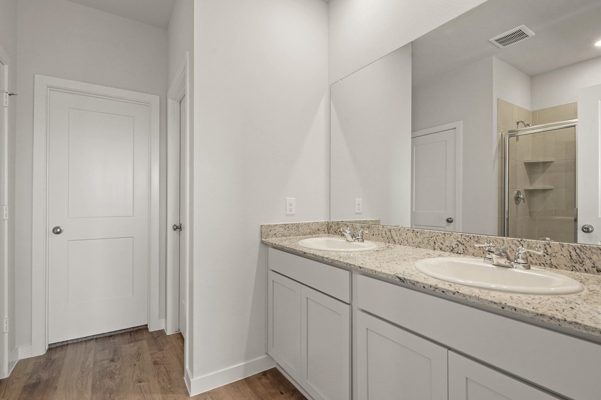 A bathroom with a large mirror.