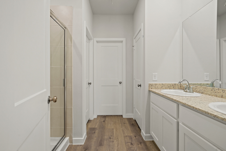 A bathroom with white cabinets.