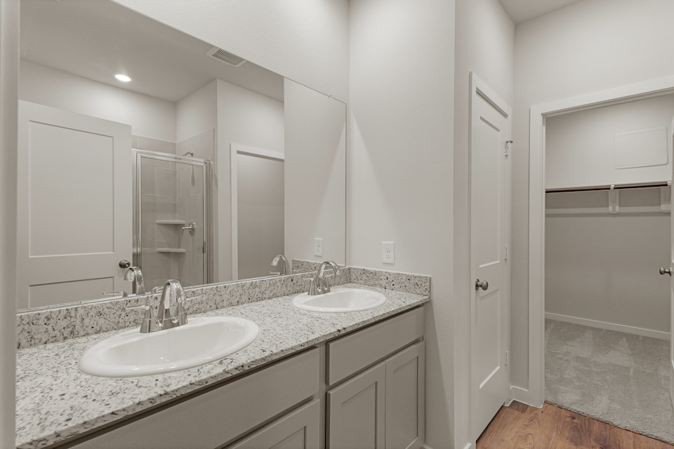 A bathroom with a large mirror.