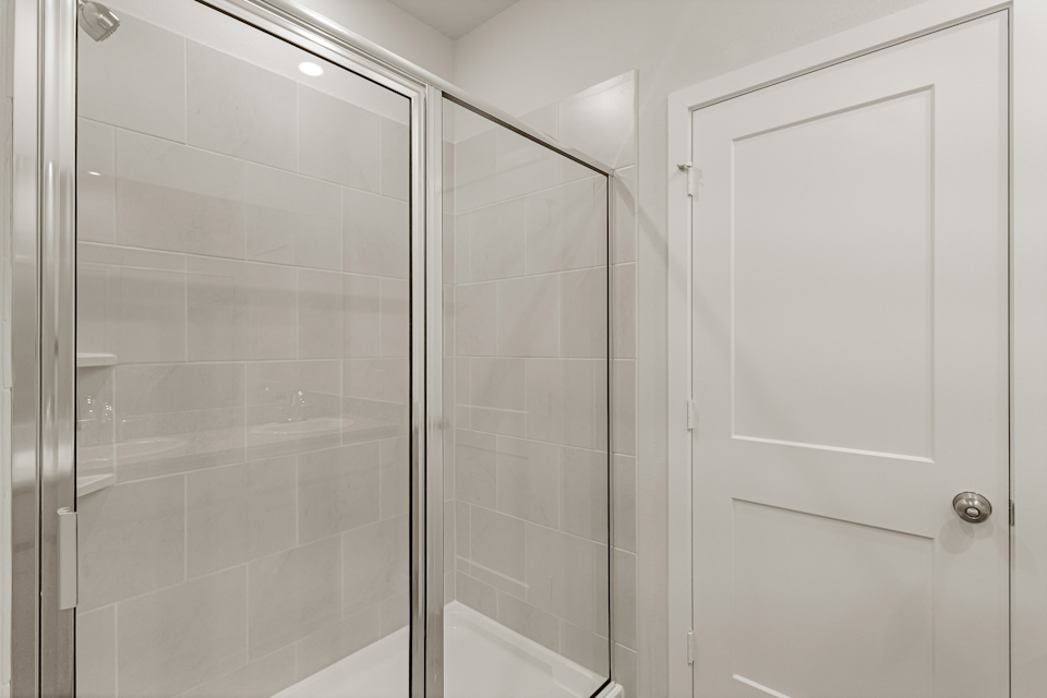 A shower with a glass door.