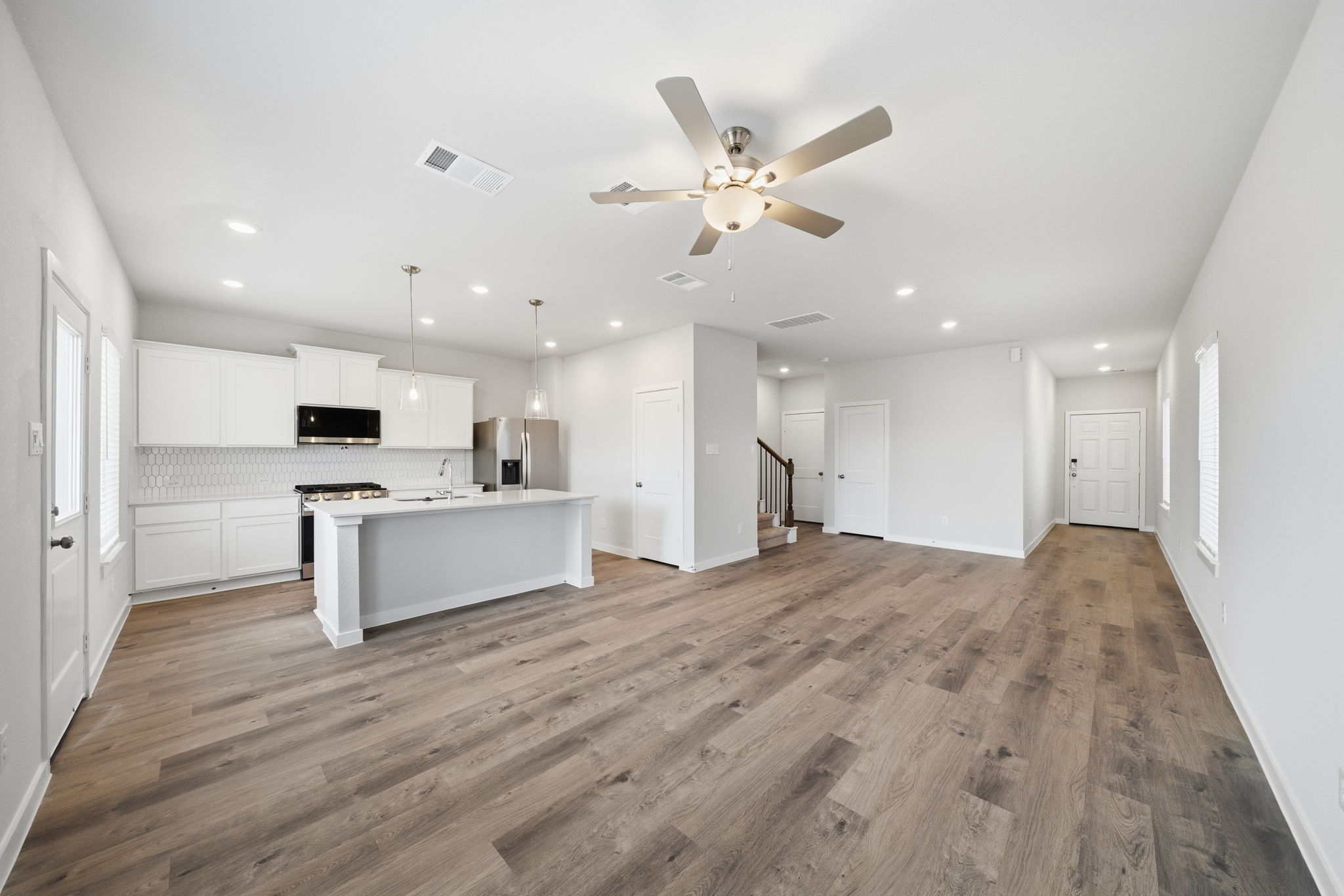 A large kitchen with white cabinets.