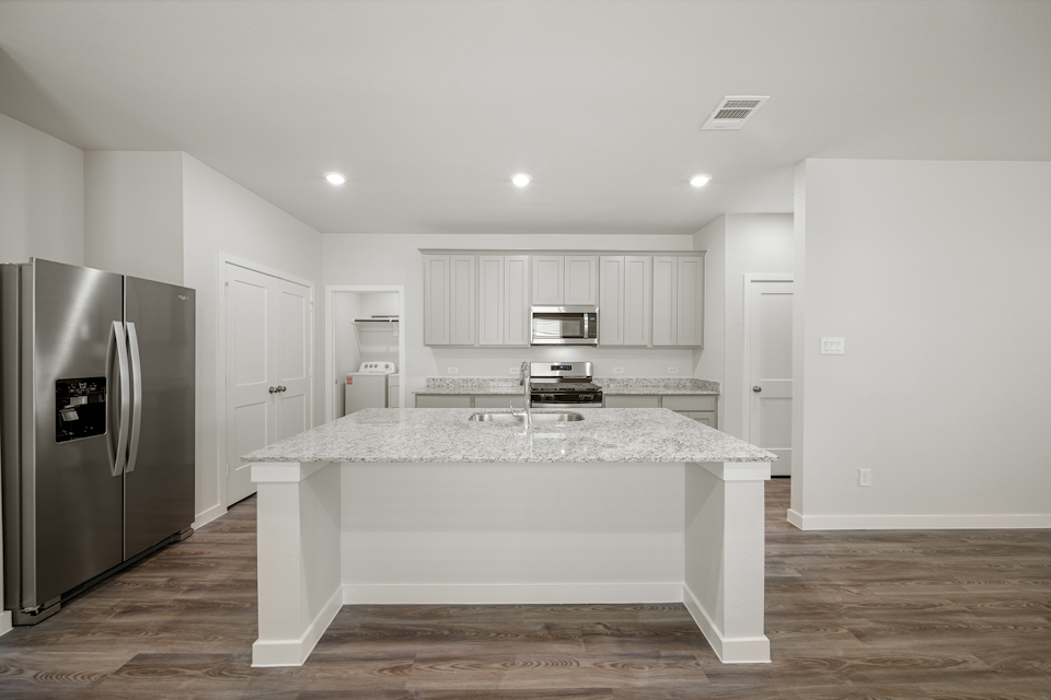 A kitchen with a marble counter.