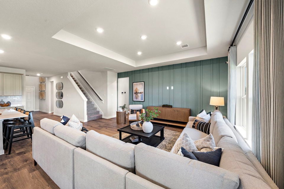 A large living room with a staircase.