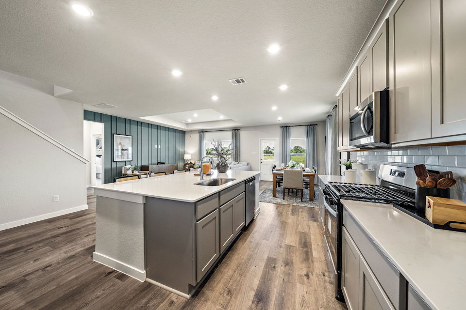 A kitchen with a wood floor.