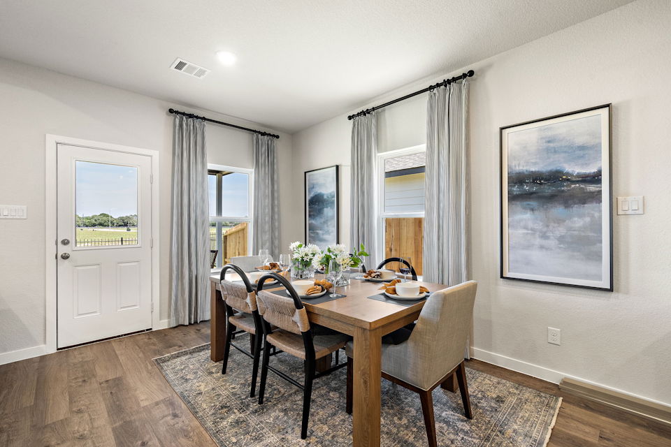 A dining room table with chairs.