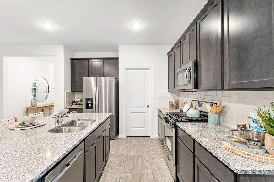 A kitchen with black cabinets.