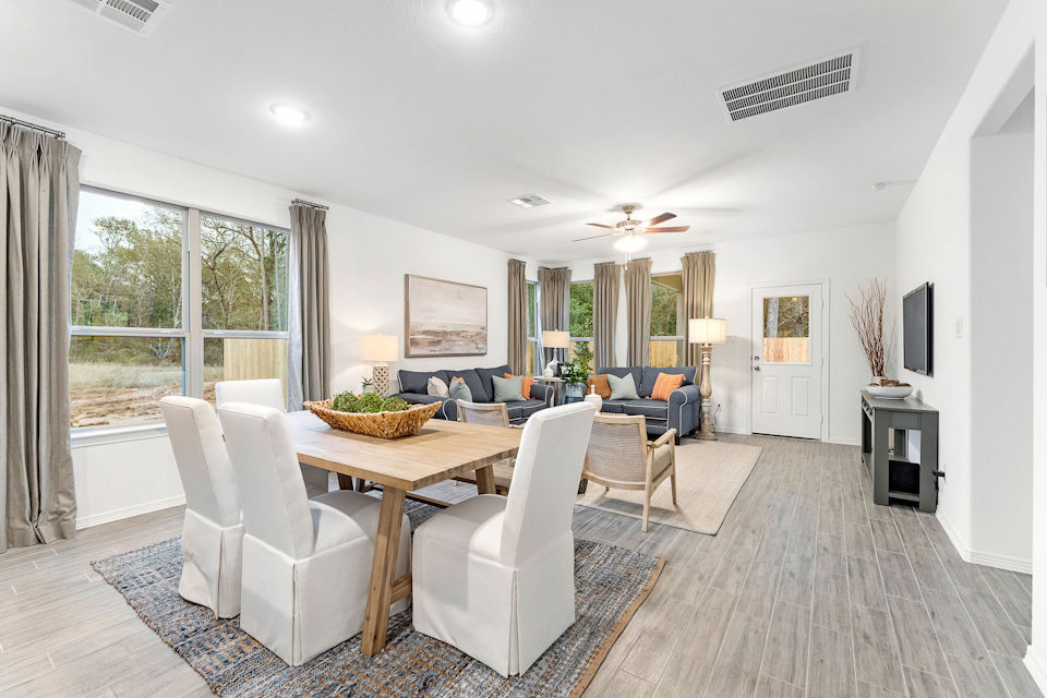 A living room with a dining table and chairs.