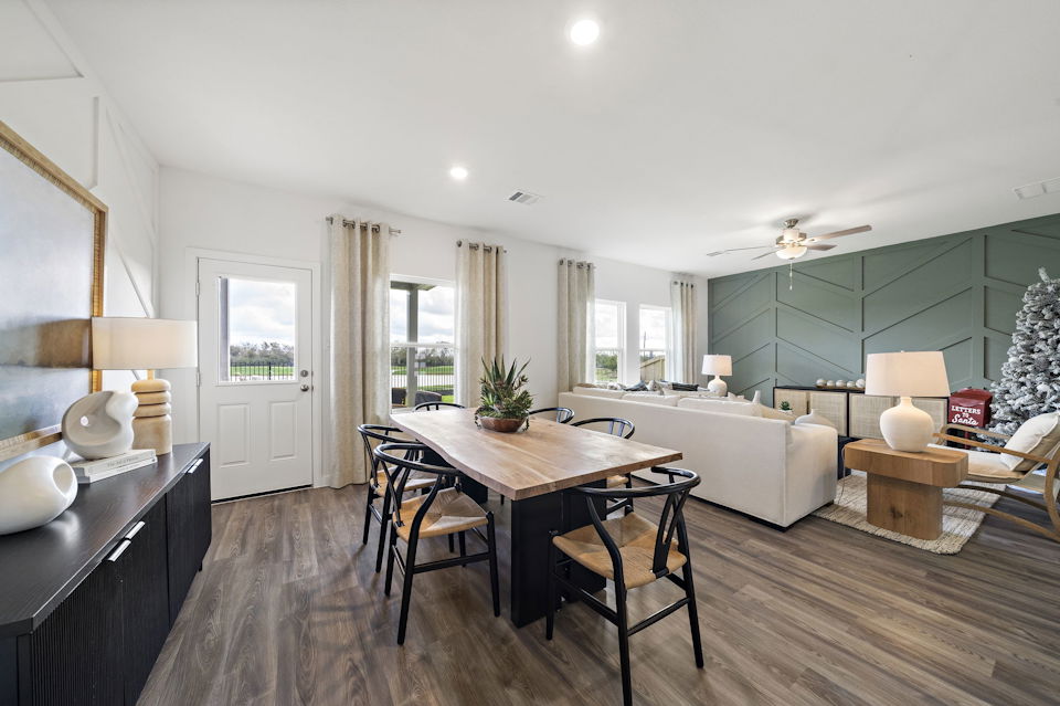 A large living room with a large table and chairs.
