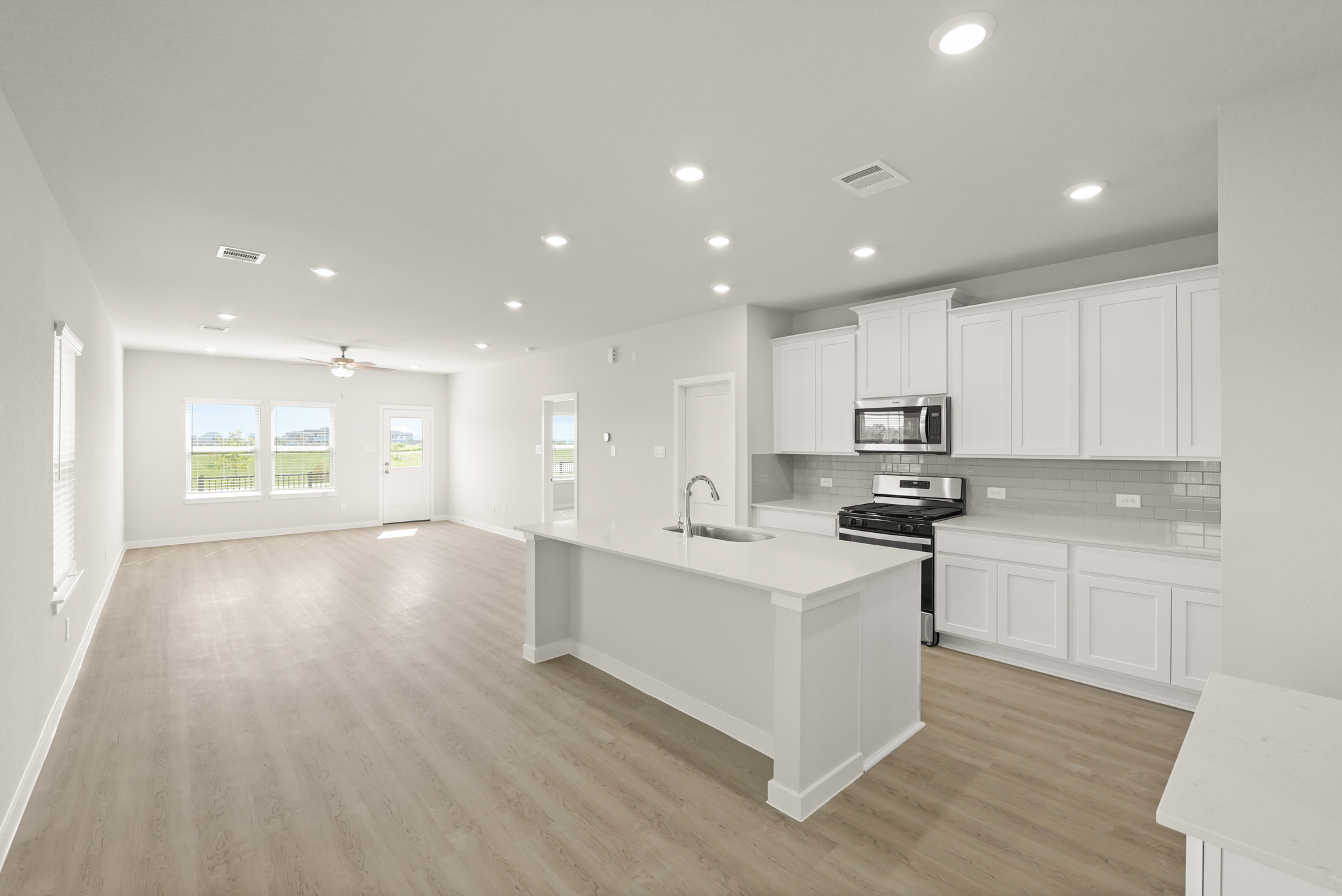 A kitchen with white cabinets.