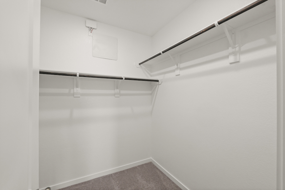 A white wall with a metal railing.