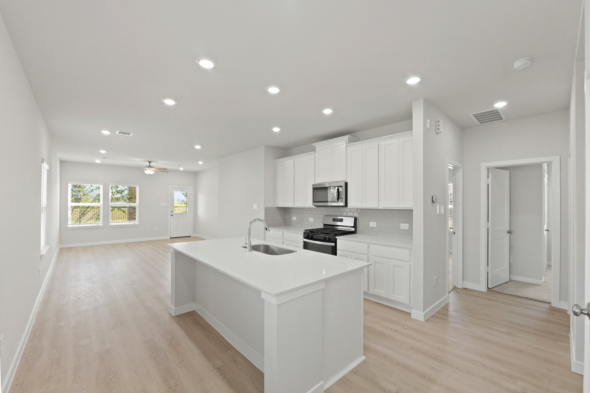 A kitchen with white cabinets.