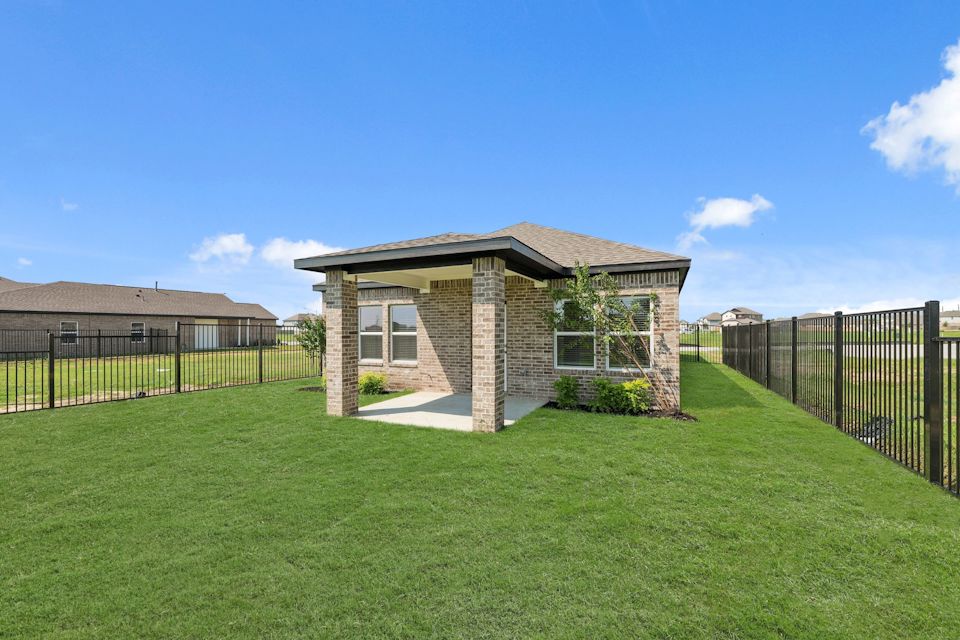 A small house in a grassy yard.