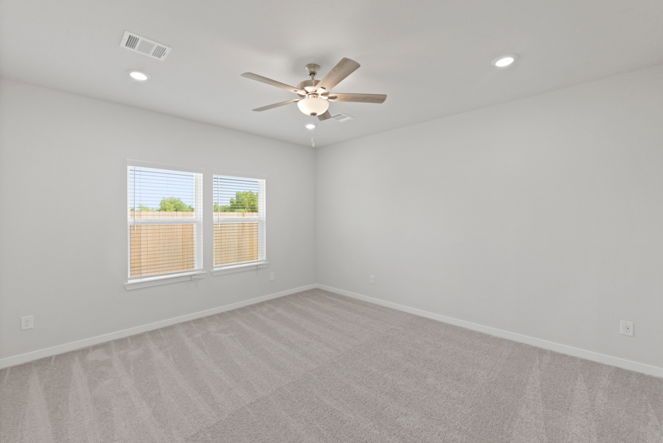 A room with a ceiling fan and a ceiling fan.