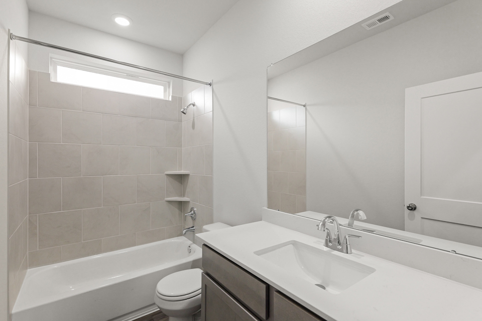 A bathroom with a tub sink and toilet.
