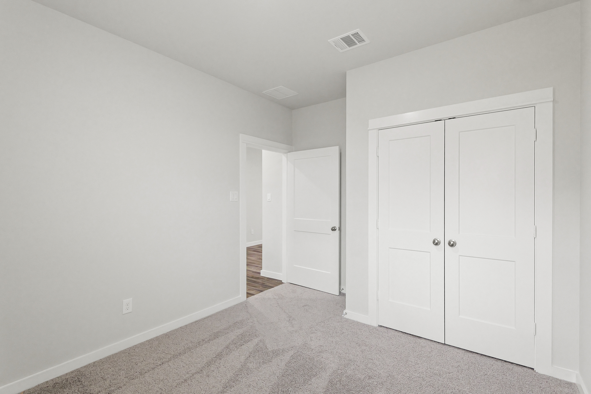 A hallway with white doors.