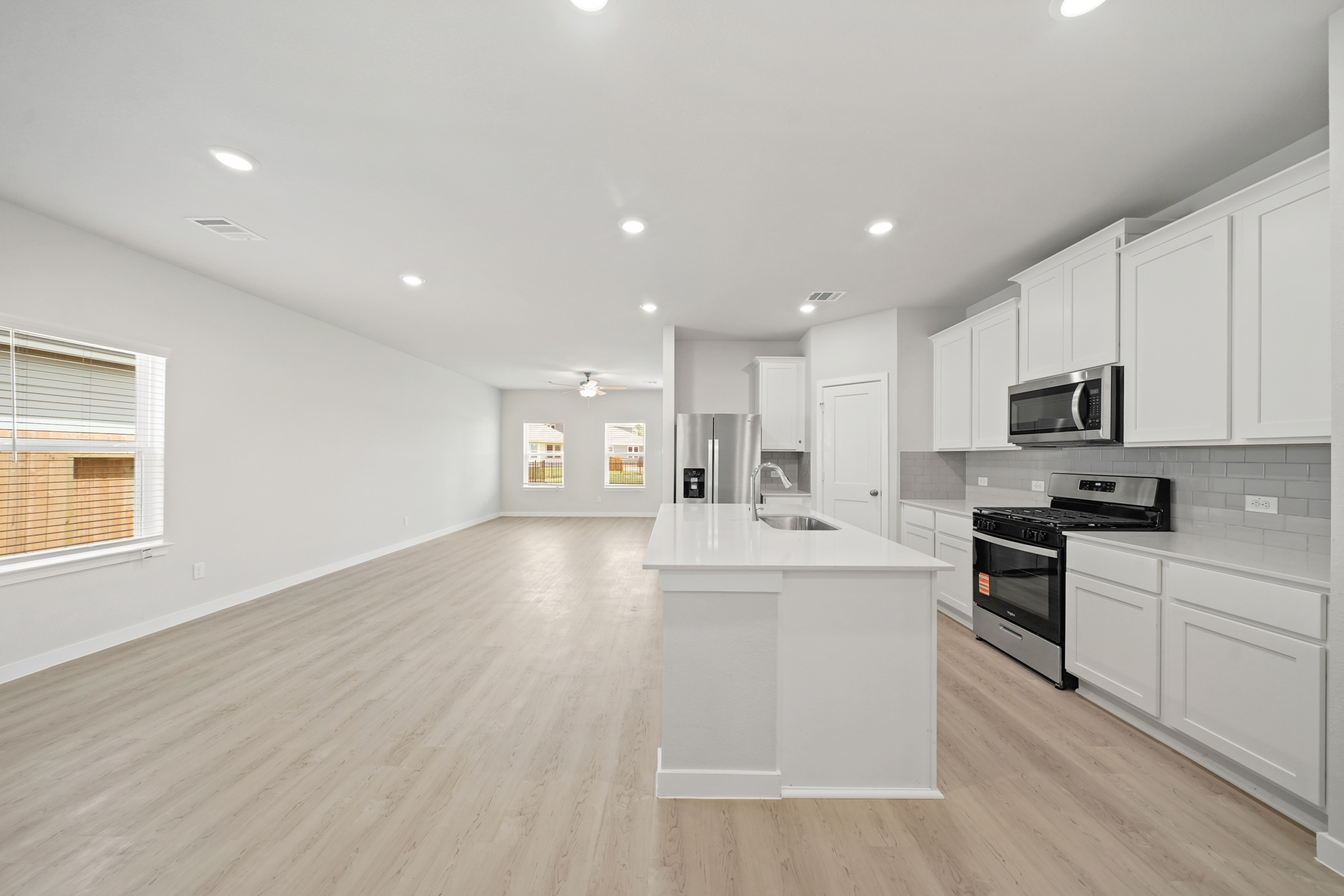 A kitchen with white cabinets.