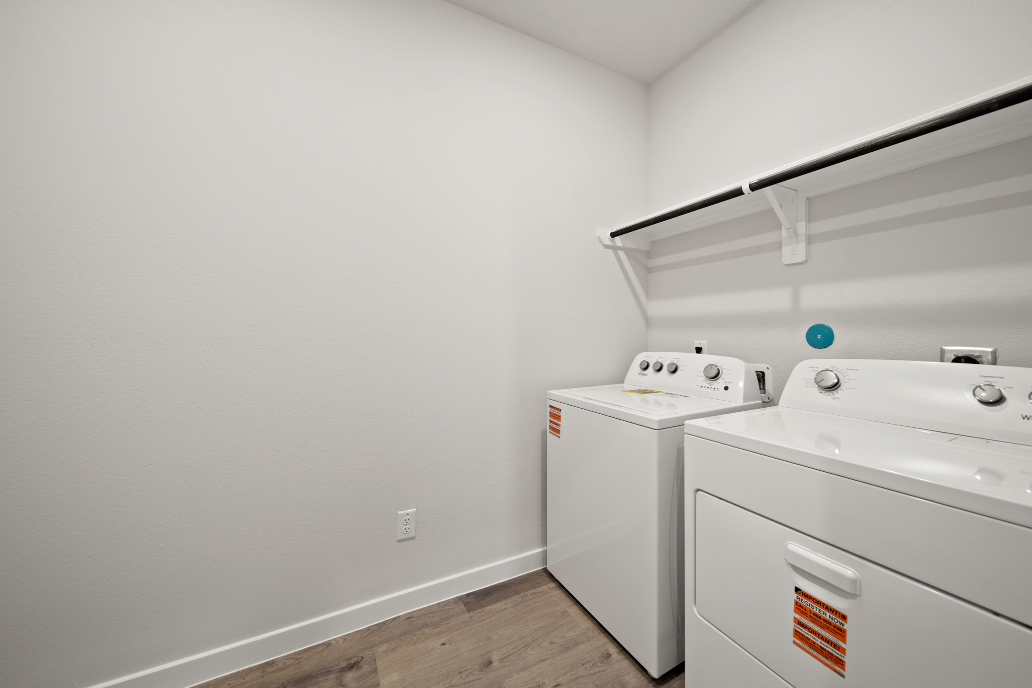 A white room with a washer and dryer.