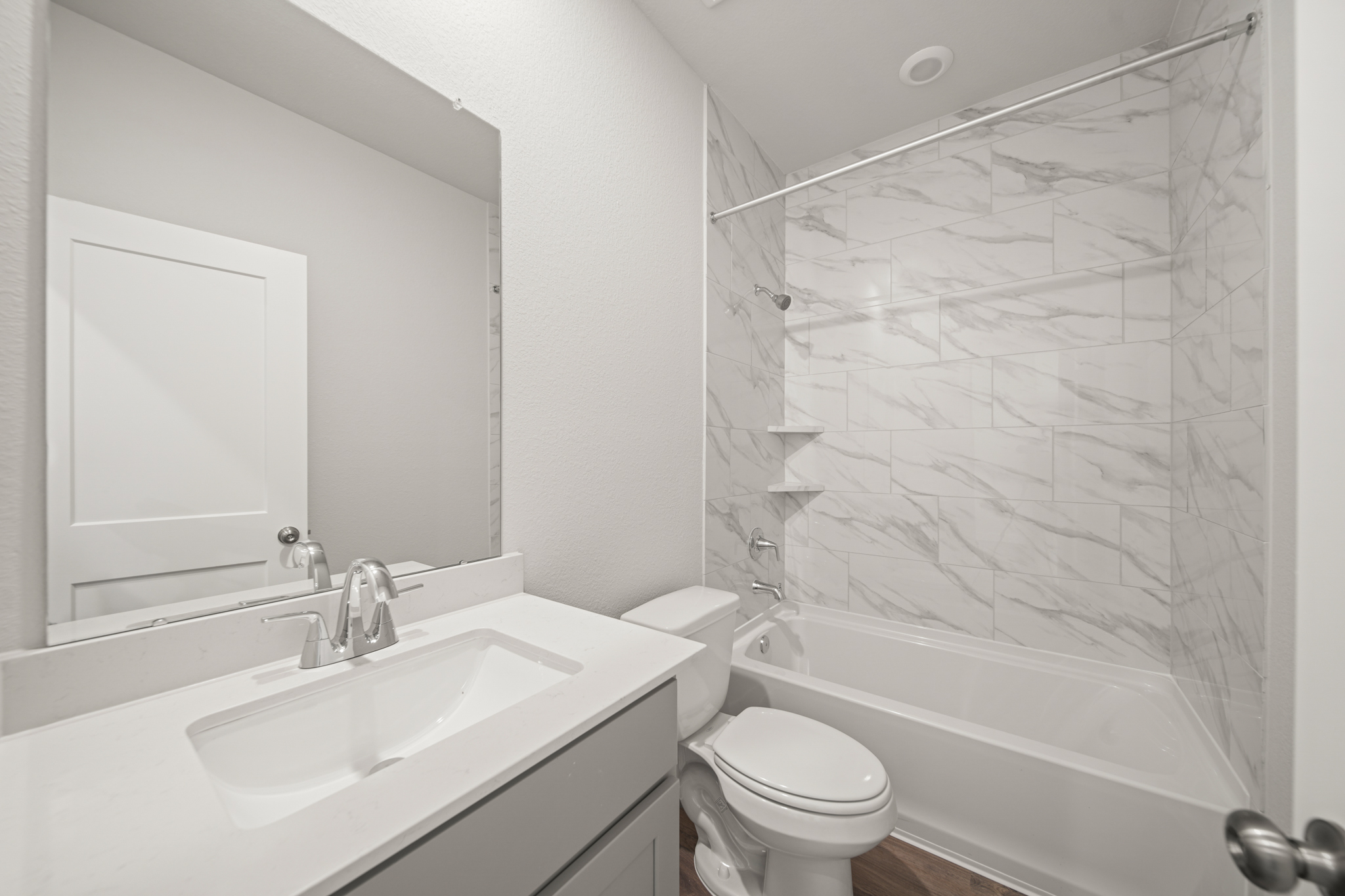 A bathroom with a shower and sink.