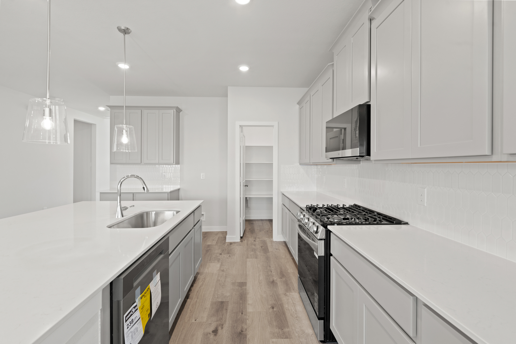 A kitchen with white cabinets.