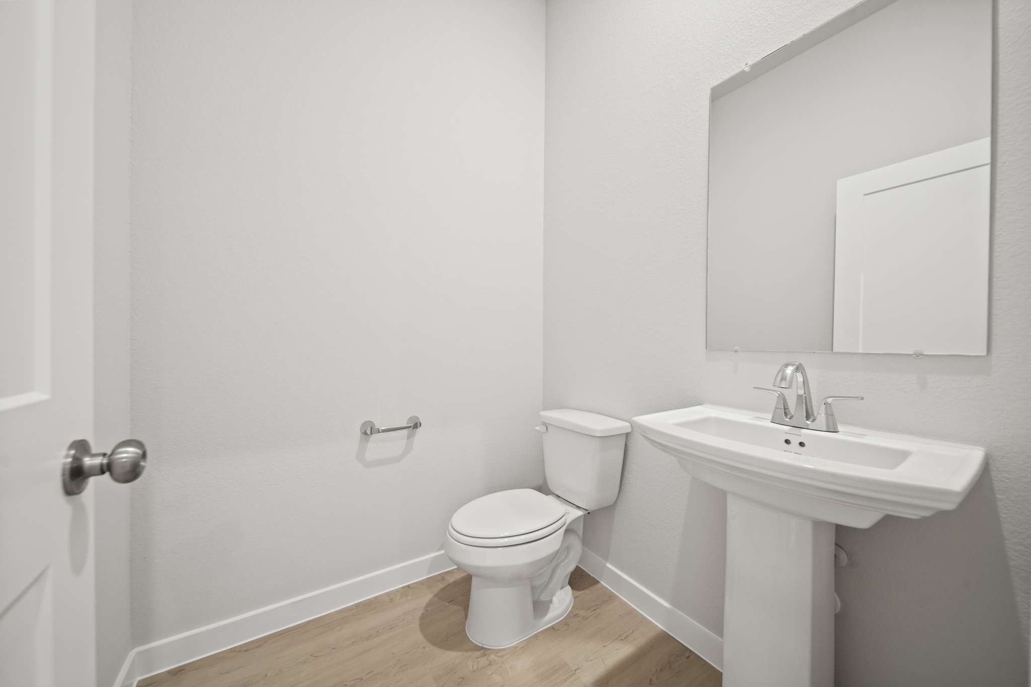 A bathroom with a toilet and sink.
