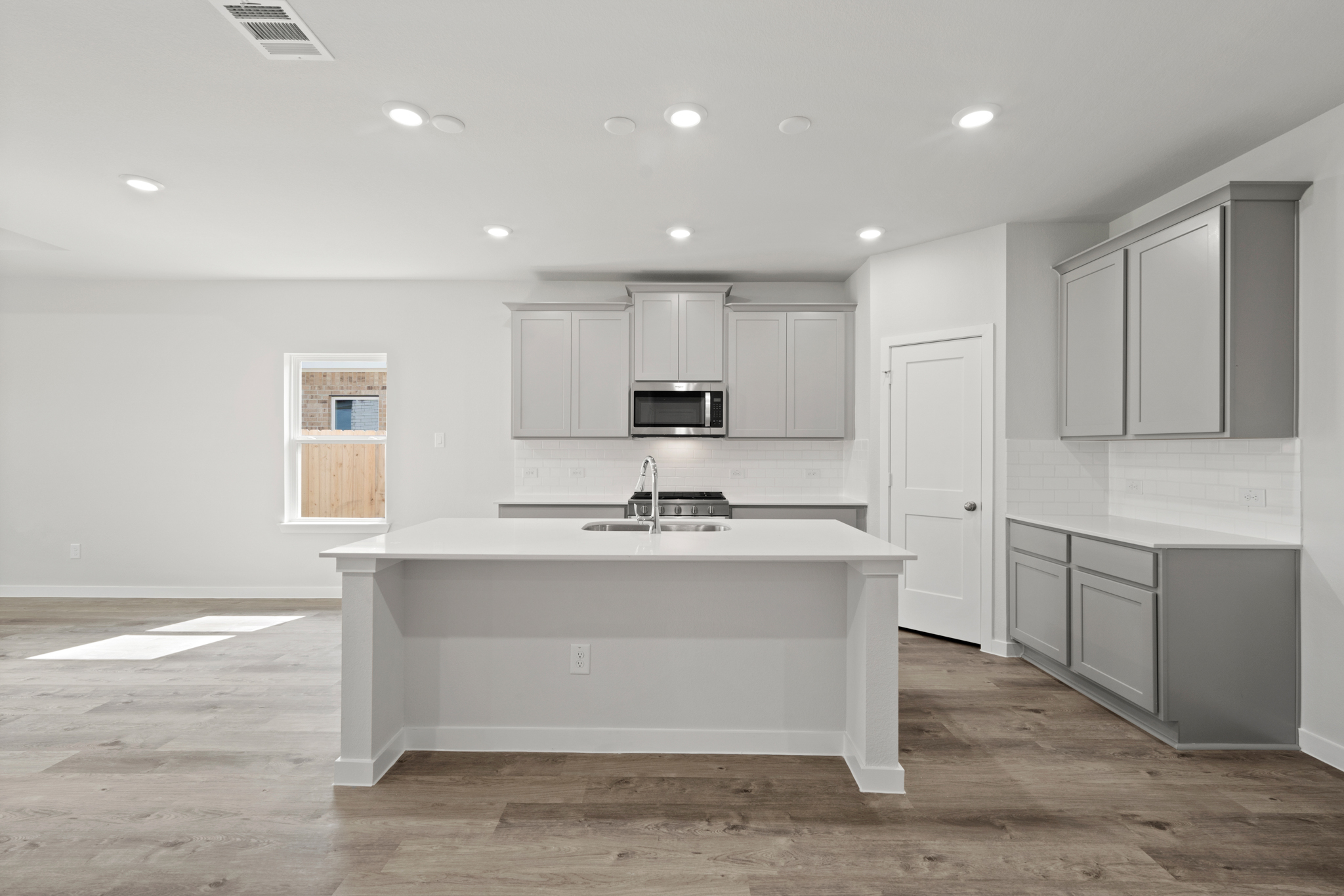 A kitchen with white cabinets.
