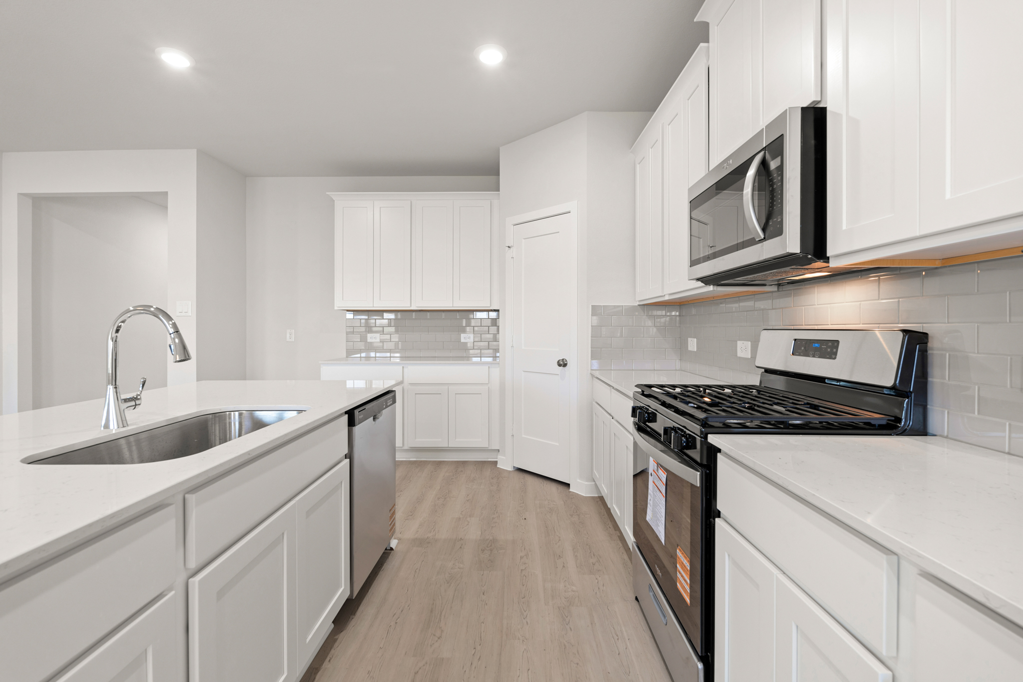 A kitchen with white cabinets.