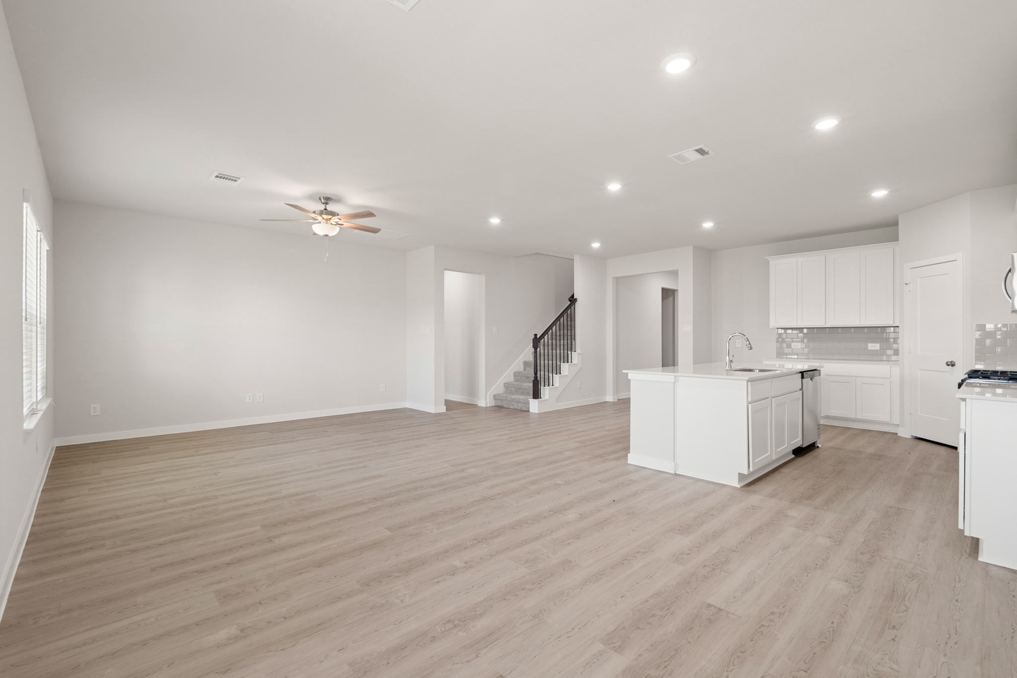 A large kitchen with white cabinets.