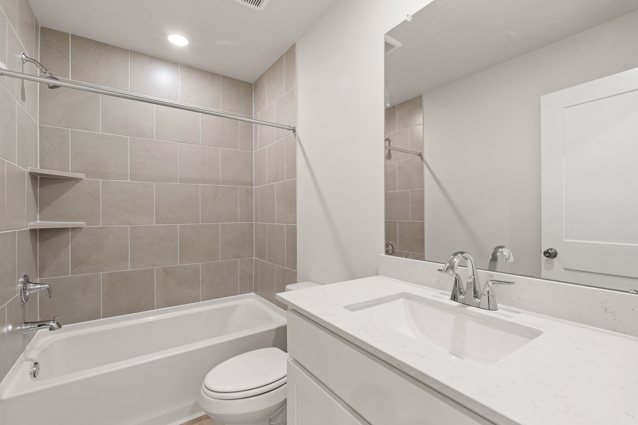 A bathroom with a tub sink and toilet.