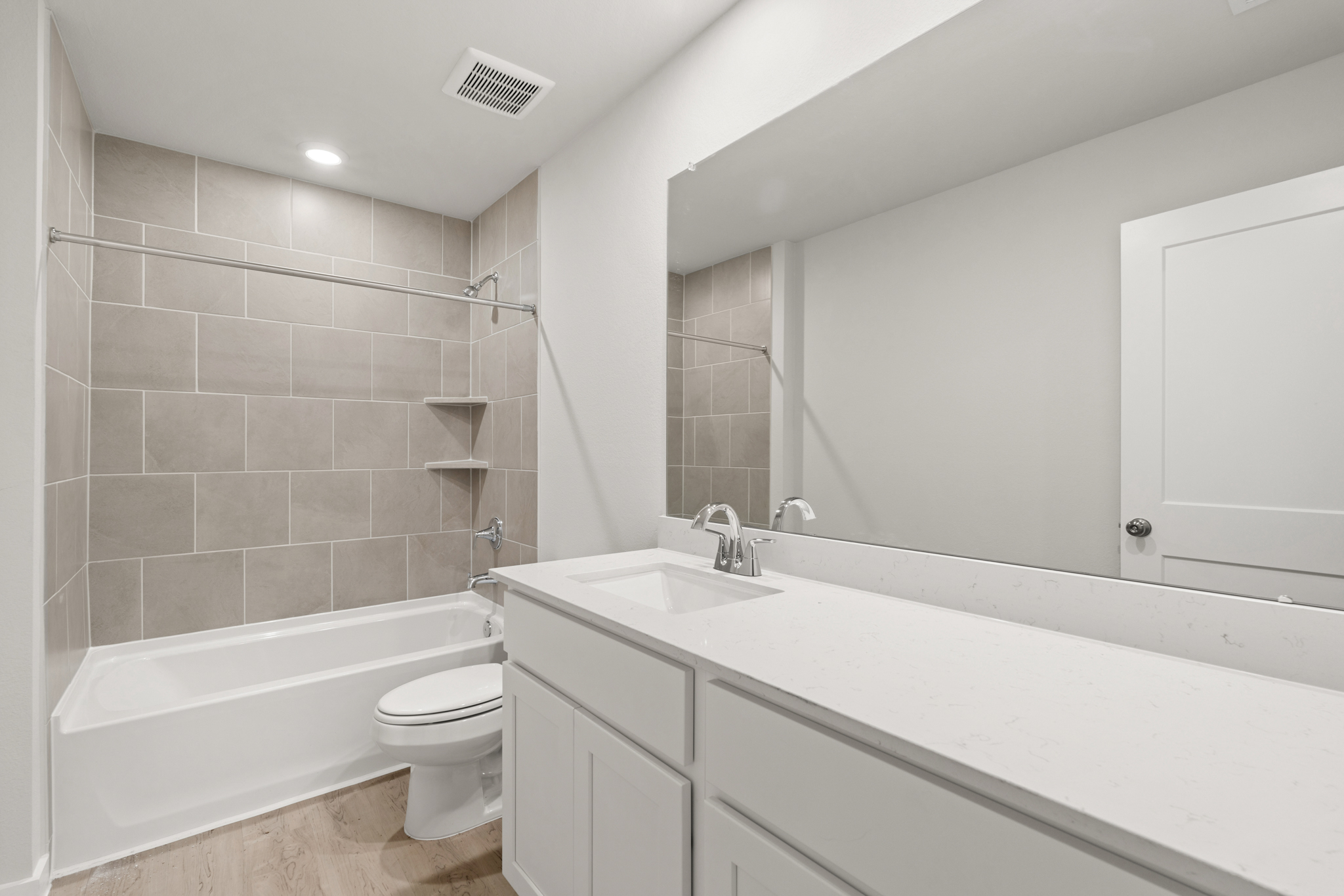 A bathroom with a tub sink and toilet.