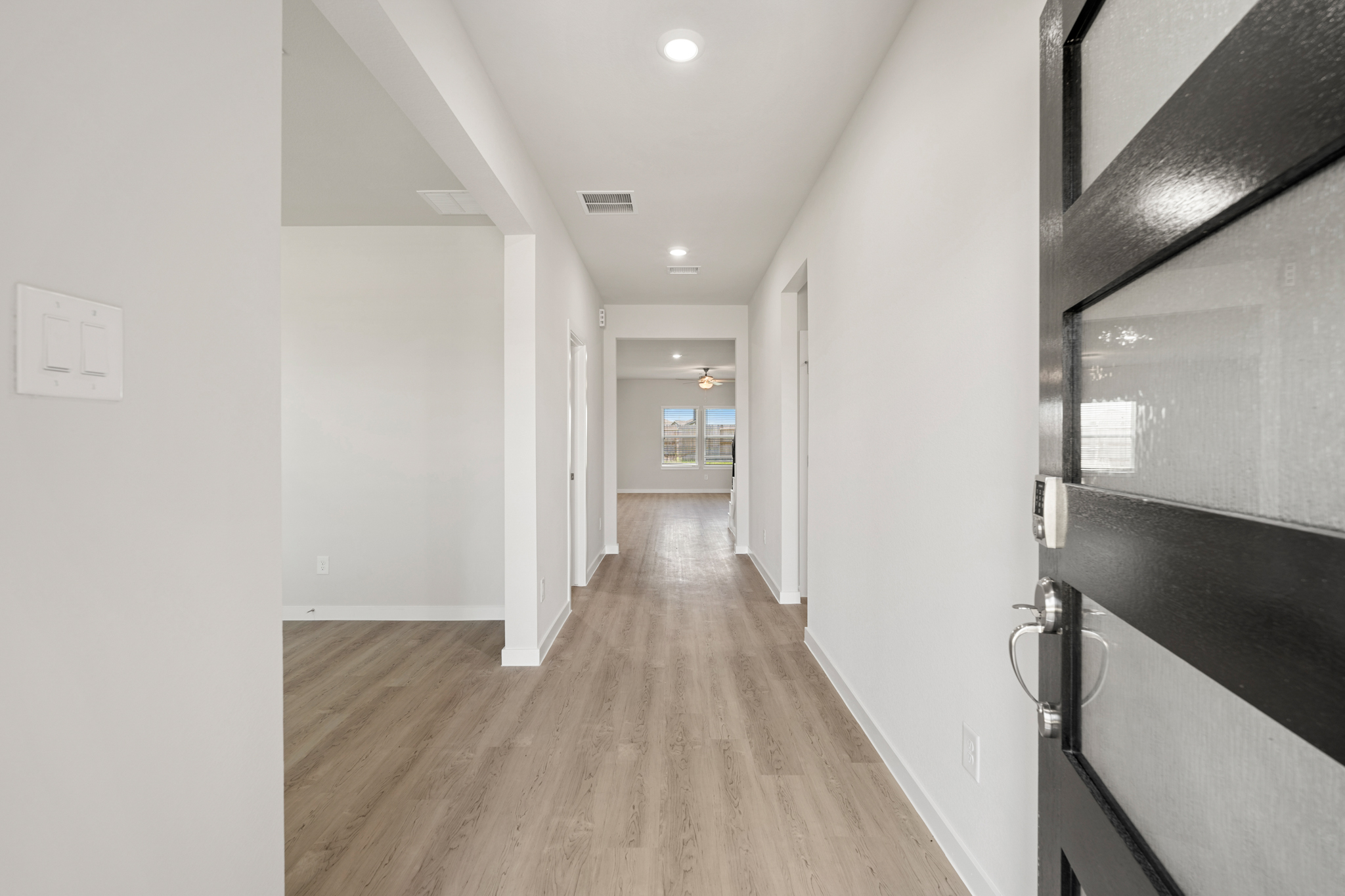 A hallway with white walls.