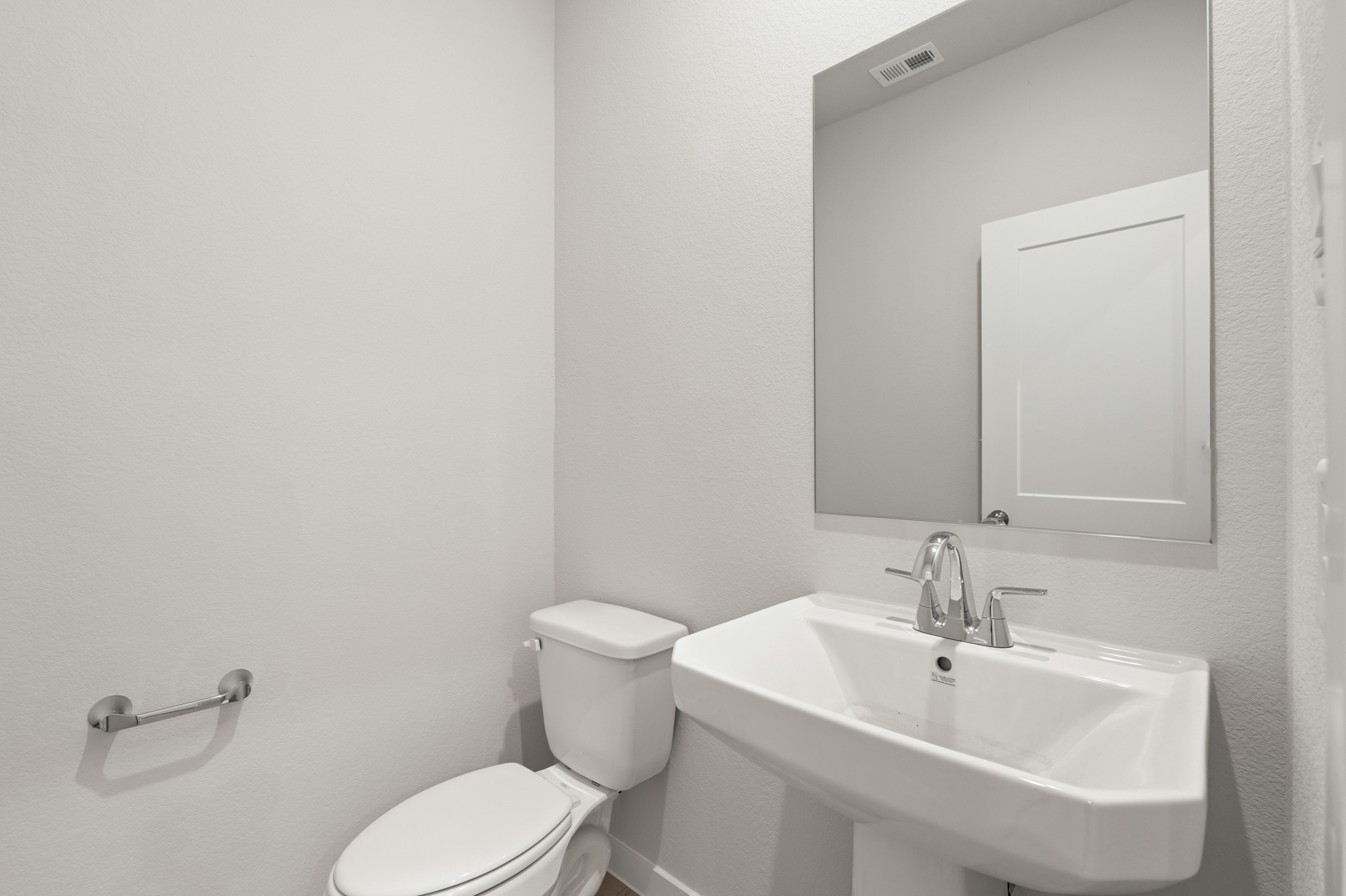 A bathroom with a toilet and sink.