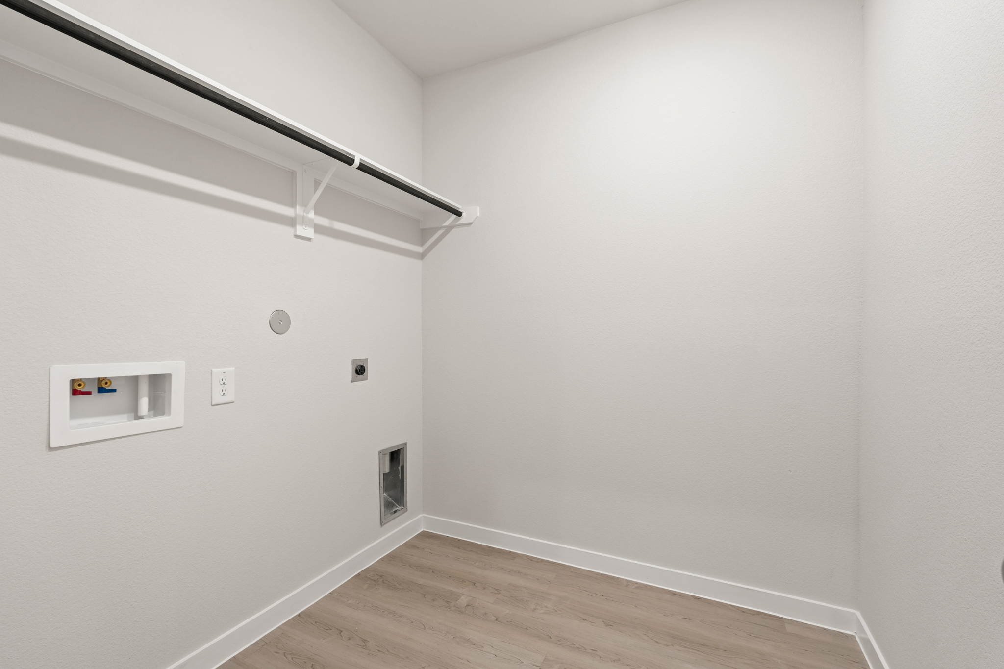 A white room with a wood floor.