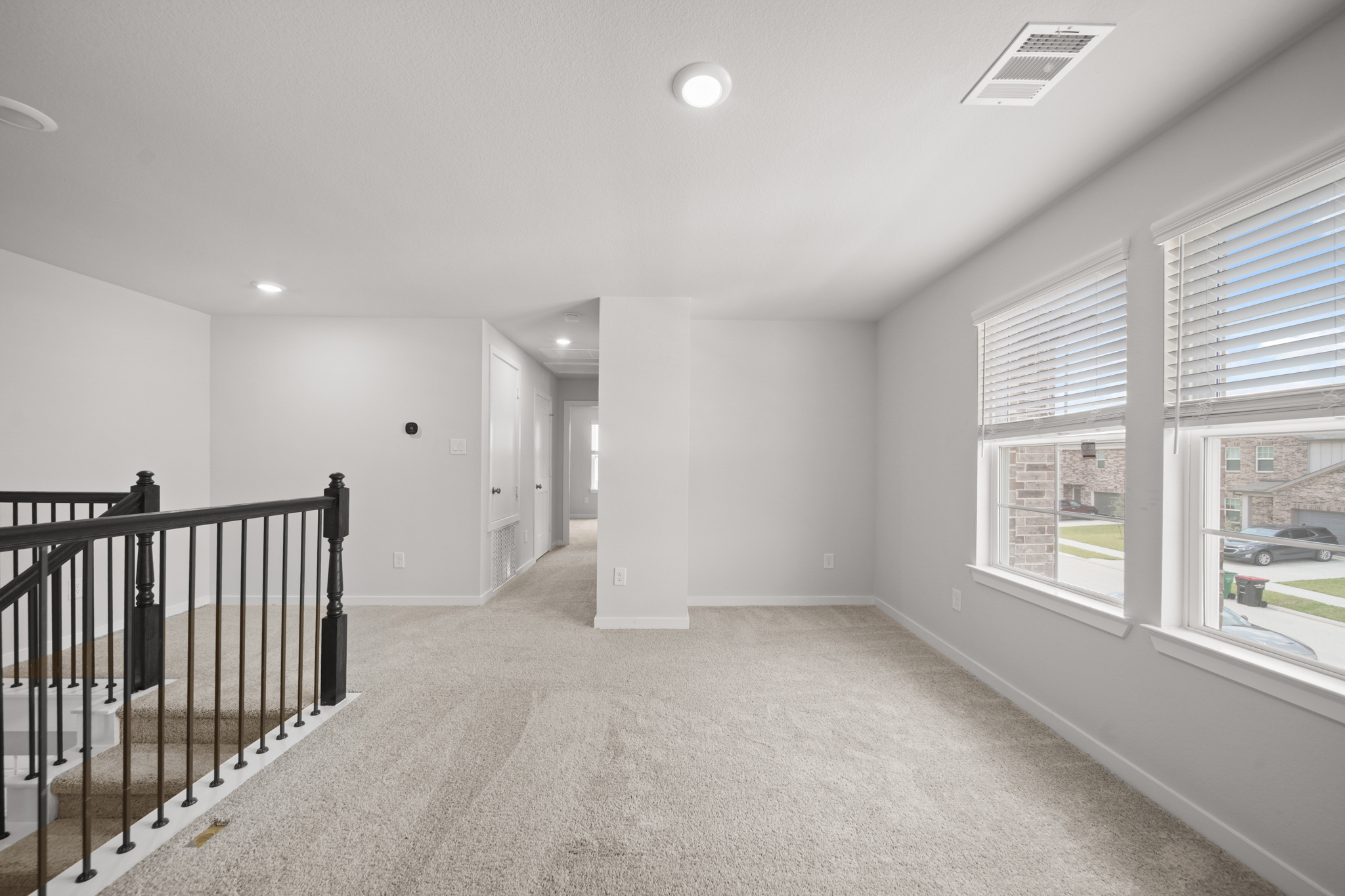 A large empty room with a railing.