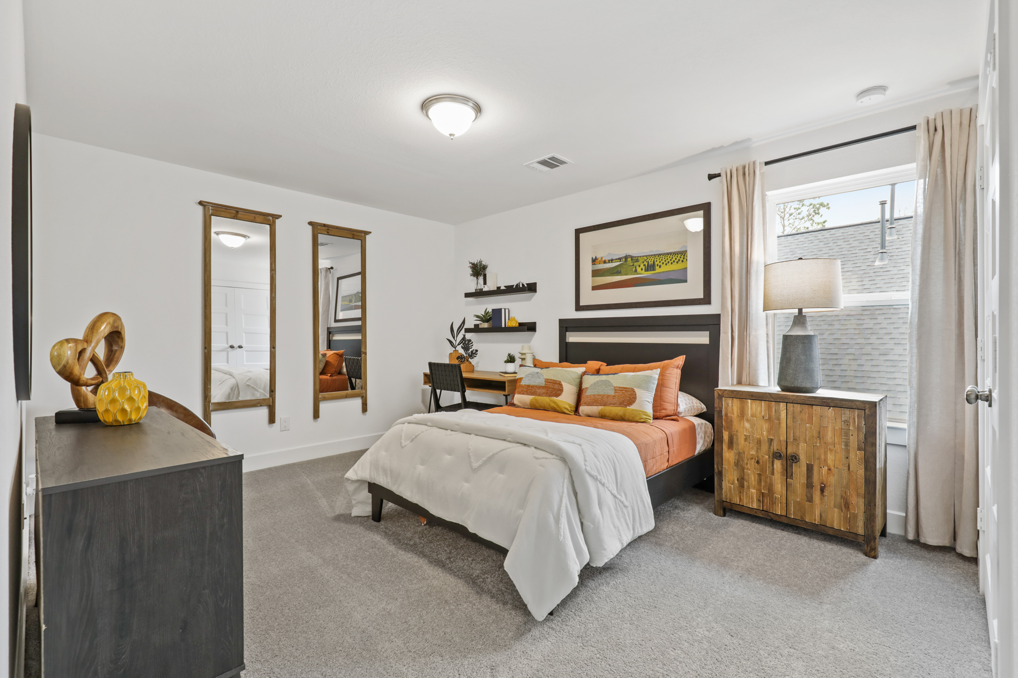 A bedroom with a bed and a desk.