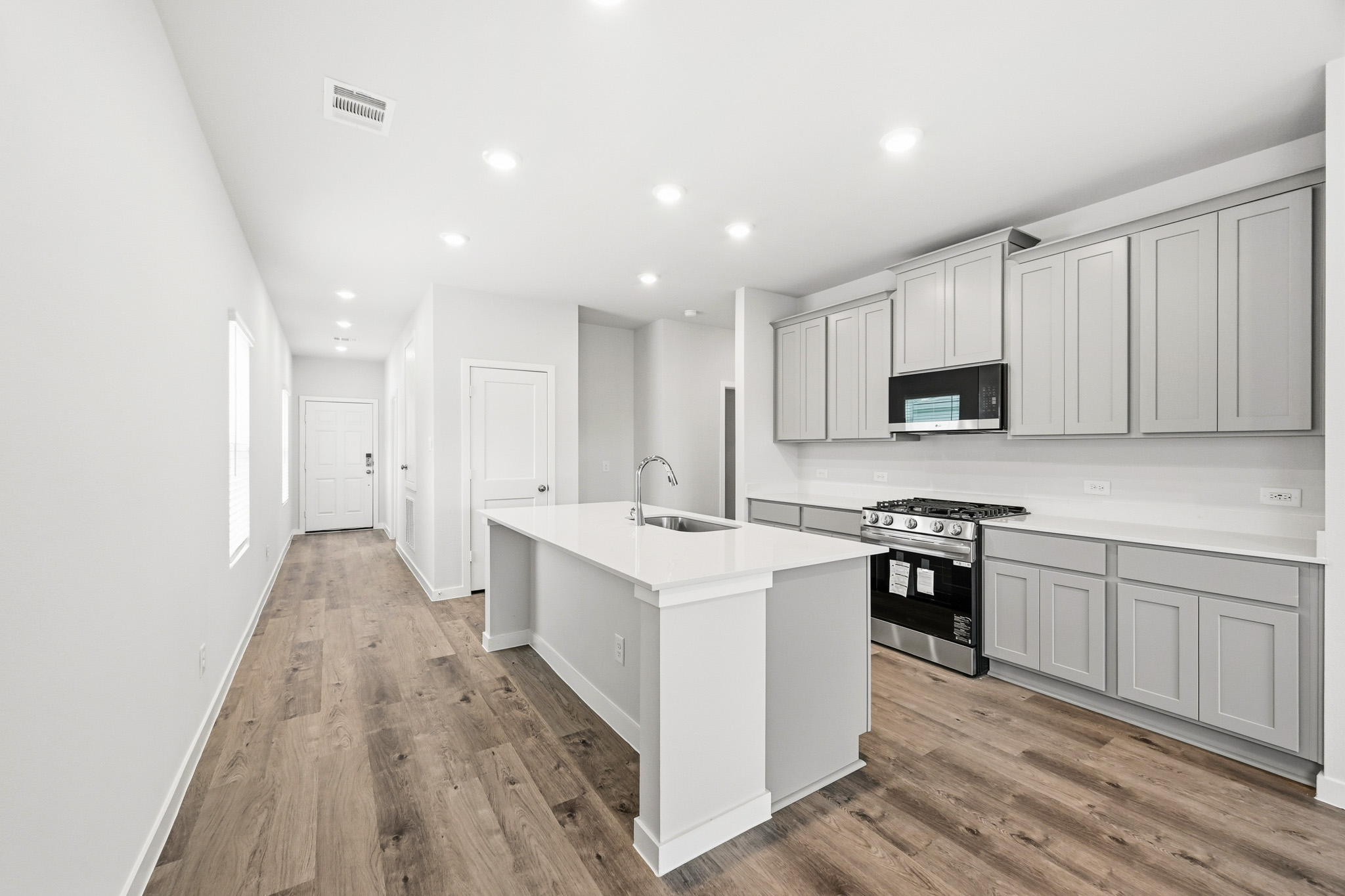 A kitchen with white cabinets.