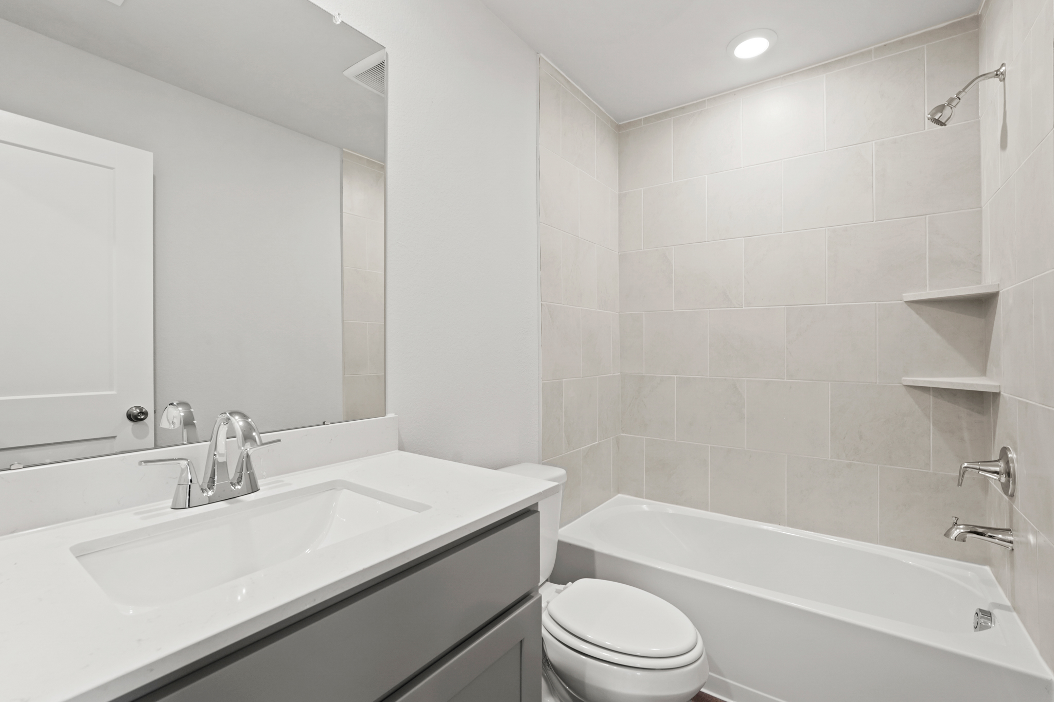 A bathroom with a tub sink and toilet.