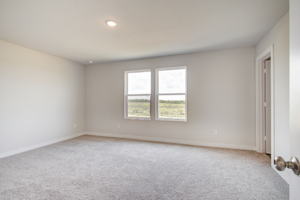 A room with a window and carpet.